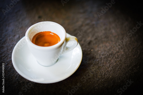 Homemade fresh espresso shot  coffee or latte  with cup   ceramic saucer serve on black table  for beverage background - healthy diet concept.