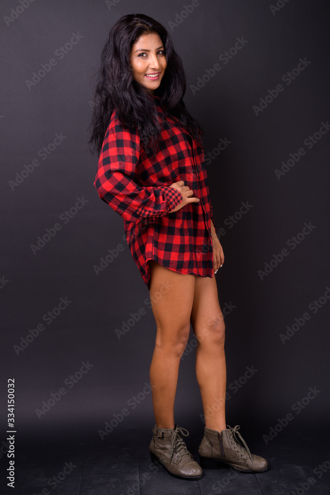 Full body shot of happy young beautiful Indian hipster woman smiling Full body shot of happy young beautiful Indian hipster woman smiling