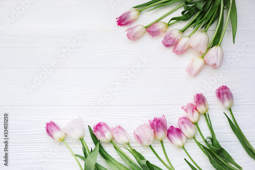 Fototapeta Naklejka Na Ścianę i Meble -  Frame from Pink Tulips Flowers on white table for March 8, Women's Day, Birthday, Valentine's Day or Mother's day - Closeup