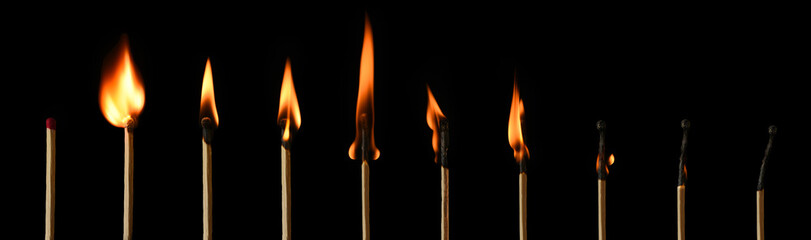 The stages of match burning on a black background. Safe match with red head. Different stages of matchstick burning. From Ignition to decay. Copy space, banner. 