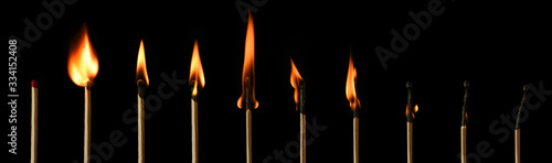 The stages of match burning on a black background. Safe match with red head. Different stages of matchstick burning. From Ignition to decay. Copy space, banner. 