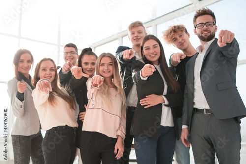 group of confident young business people pointing at you