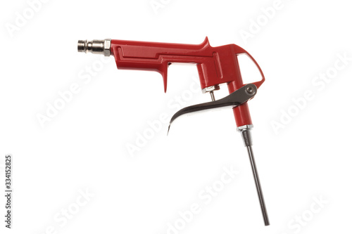 Red aluminum compressed air brush gun for use with compressor, isolated on white background