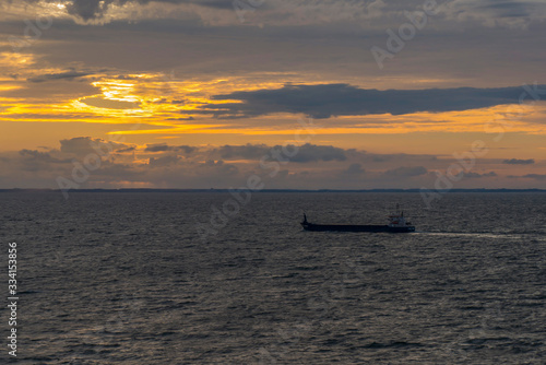 sunset from the north sea and a merchant ship