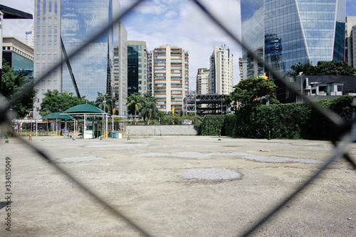 Empty Parking Lot in Itaim Bibi, during coronavirus outbreak, Sao Paulo, Brazil with some cyclists - March 2020 photo