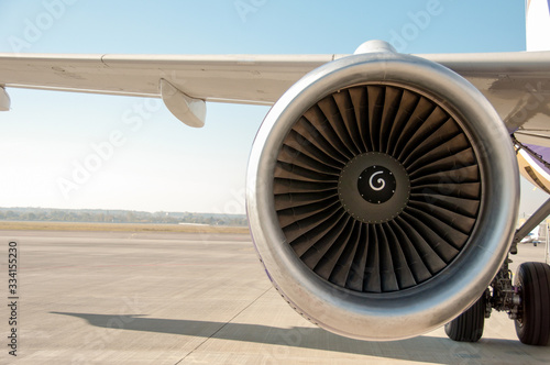 Maintenance of engine in an airplane. Turbine of airplane. Jet airplane wing and engine front view. Turboprop aircraft engine closeup shot. Turbine blades of aircraft jet engine.