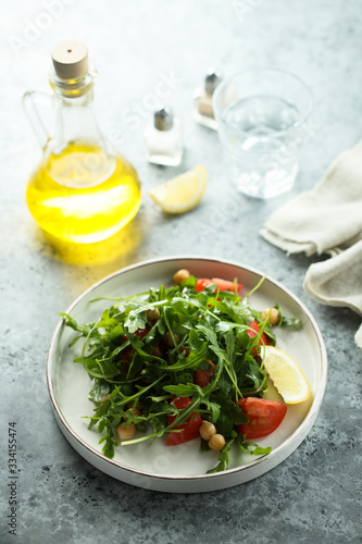Healthy arugula salad with chickpeas and tomato