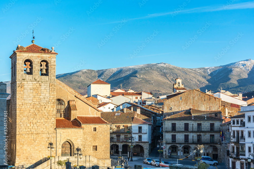 Church of El Salvador in the main square of Maldonado in Béjar, province of Salamanca in the background the mountains of Gata (Spain)