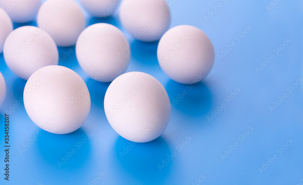 White eggs on a blue background. Copy space. White eggs on a blue background. Copy space.