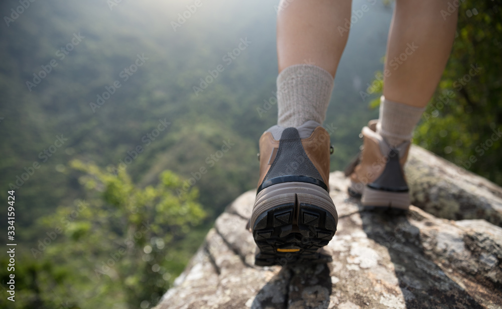Successful hiker enjoy the view on mountain top cliff edge Successful hiker enjoy the view on mountain top cliff edge