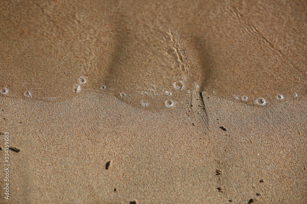 Abstract background of a sandy beach and sea foam with negative space Abstract background of a sandy beach and sea foam with negative space