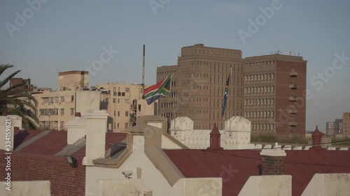 Two waving flags of South Africa on the roof of the building in Johannesburg, the third largest city in South Africa.