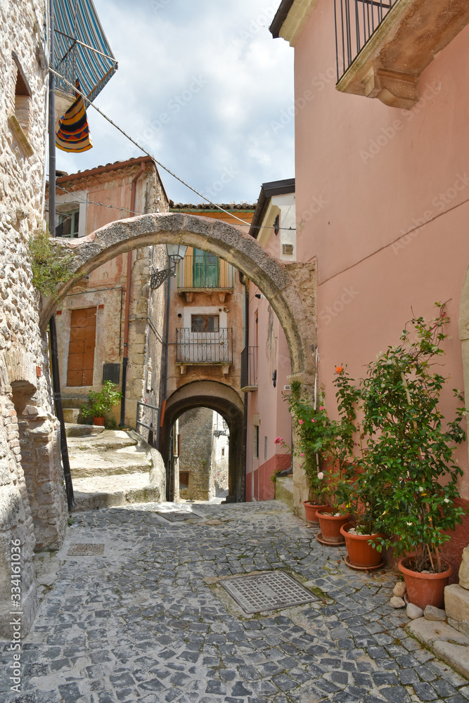 Fototapeta Pacentro, Italy. A narrow street between the old houses of a medieval village