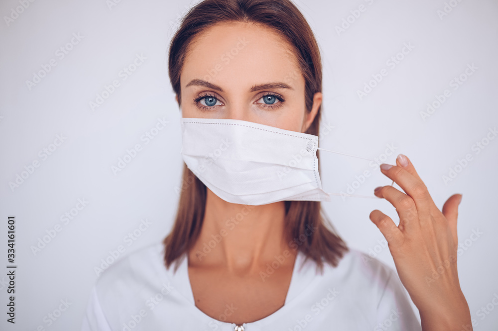 Close up portrait of beautiful young european woman doctor nurse wearing protective mask corona virus prevention. Free space for text mockup banner. Avoid contaminating Corona virus Covid-19 concept Close up portrait of beautiful young european woman doctor nurse wearing protective mask corona virus prevention. Free space for text mockup banner. Avoid contaminating Corona virus Covid-19 concept