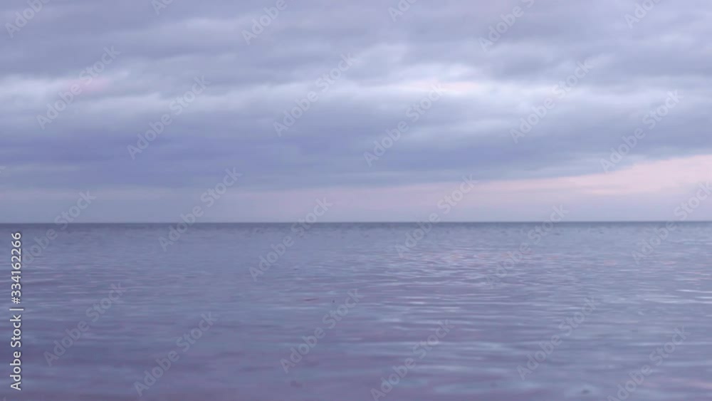 Birds flying low over the calm sea on a cloudy evening at the Baltic Sea in Latvia Birds flying low over the calm sea on a cloudy evening at the Baltic Sea in Latvia