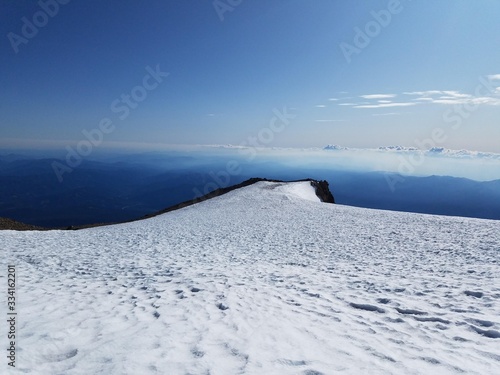The top of a snowy ridgeline offers a dramatic view of the sky © Simon