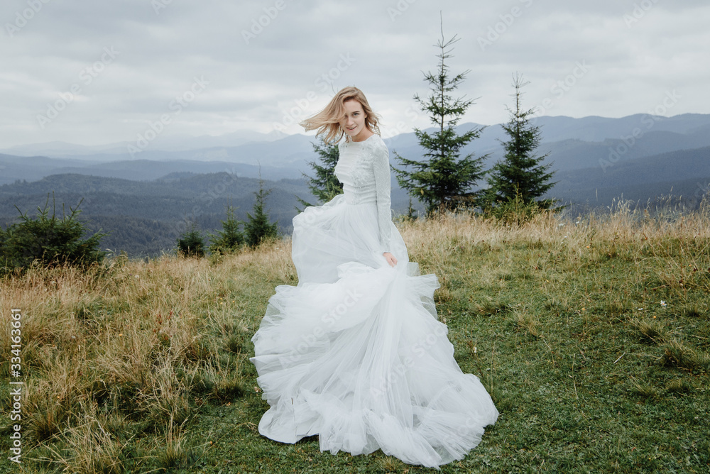 Photoshoot of the bride in the mountains. Boho style wedding photo.