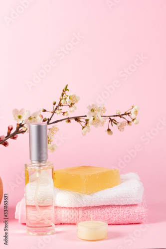 Spa concept on a pink background with a branch of a apricots