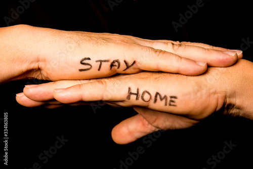 overlapped hands on which is inscribed stay home