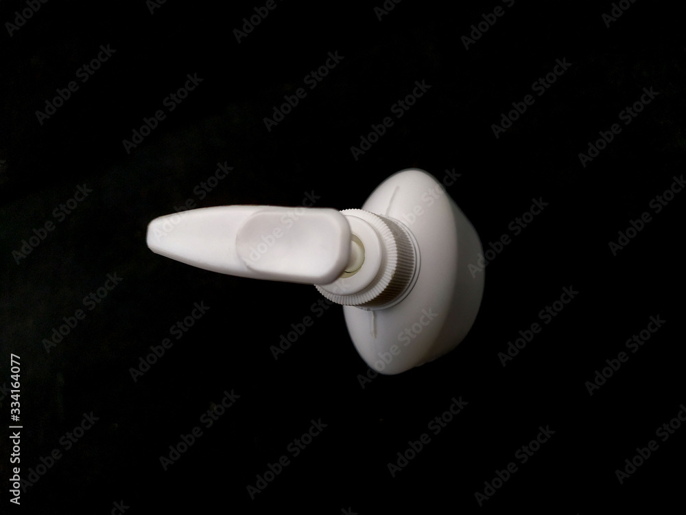 white plastice hand sanitizer bottle isolated on black background white plastice hand sanitizer bottle isolated on black background