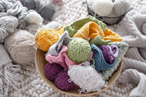 Multicolored balls of thread for knitting in the basket.