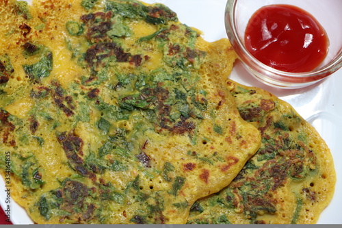 Bathuwa Chilla or Besan cheela is a simple pancake made with chickpea flour, a leafy vegetable and some basic ingredients photo
