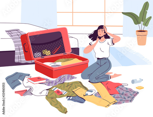 A young woman packs her suitcase and thinks what to take with her on the road and whether the flight will be canceled. Collecting things on a trip. Clothes and documents lie near the suitcase