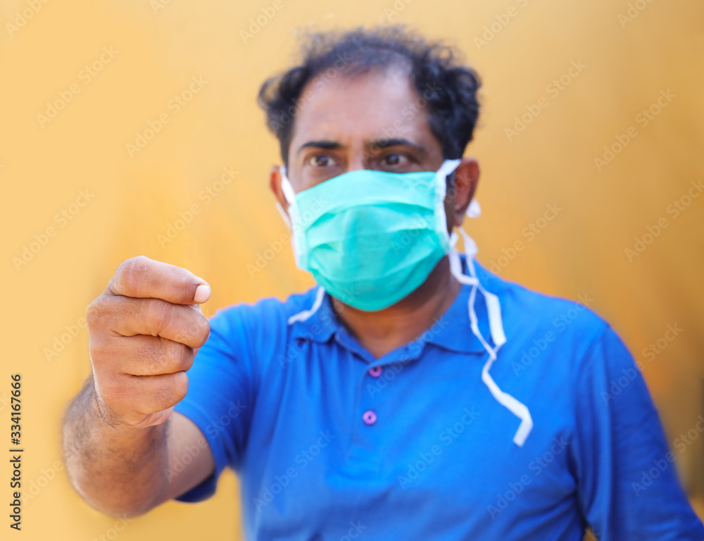 Stop the infection! Healthy man showing something. Photo of man wear protective mask against infectious diseases and flu. Health care concept. Stop the infection! Healthy man showing something. Photo of man wear protective mask against infectious diseases and flu. Health care concept.