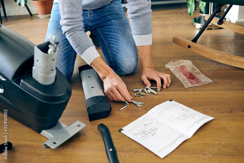 man assembling a stationary bicycle photo