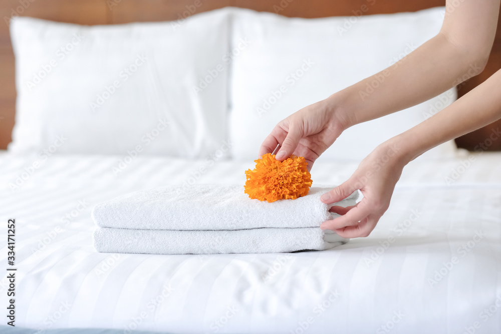 Hands of hotel maid bringing fresh towels to the hotel room Hands of hotel maid bringing fresh towels to the hotel room