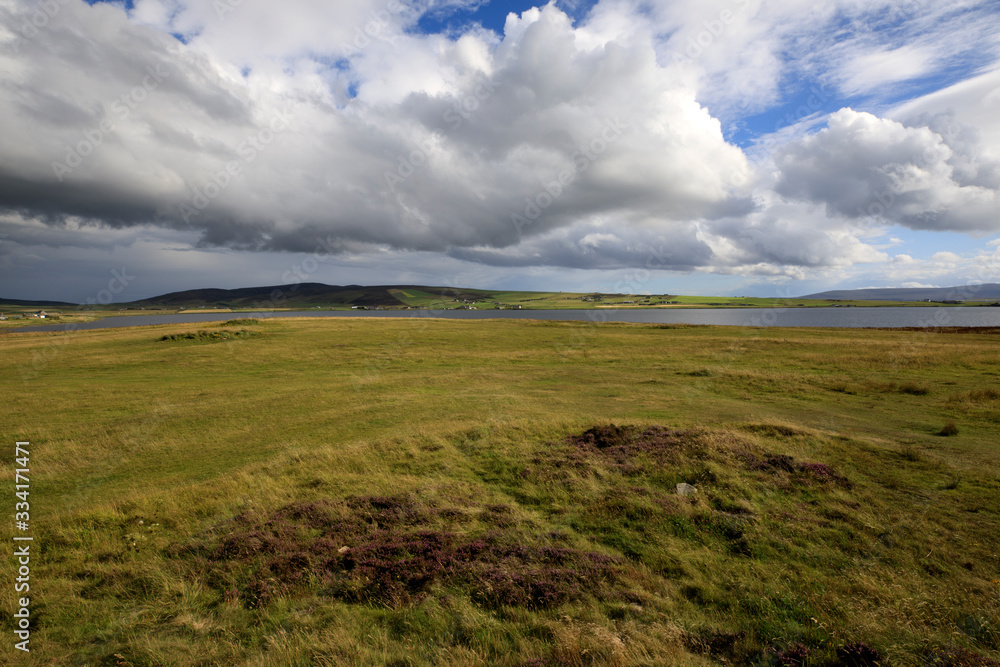 Brodgar - Orkney (Scotland), UK - August 06, 2018: The country near Ring of standing stones at Brodgar, Orkney, Scotland, Highlands, United Kingdom Brodgar - Orkney (Scotland), UK - August 06, 2018: The country near Ring of standing stones at Brodgar, Orkney, Scotland, Highlands, United Kingdom