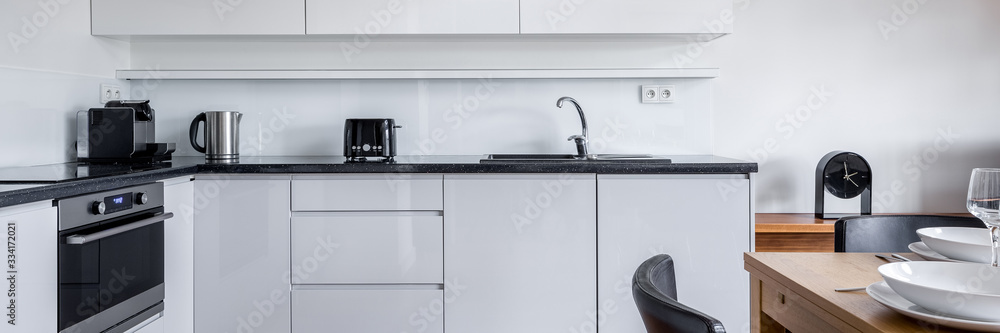 Fototapeta premium Kitchen with white furniture, panorama