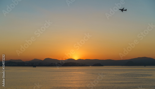 Airplane flying over Rio de Janeiro at sunrise