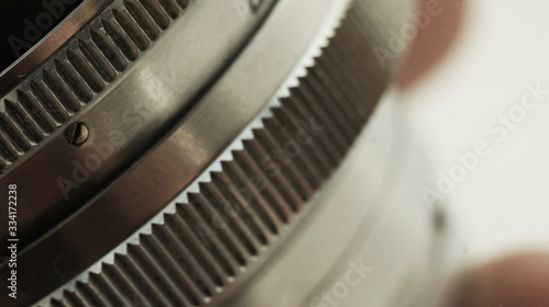 Photo camera lens close-up.Steel gears and rolling bearing. Gear. Abstract industrial background. - Image