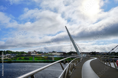 The famous Peace Bridge over Foyle river, located in Derry, Northern Ireland. photo