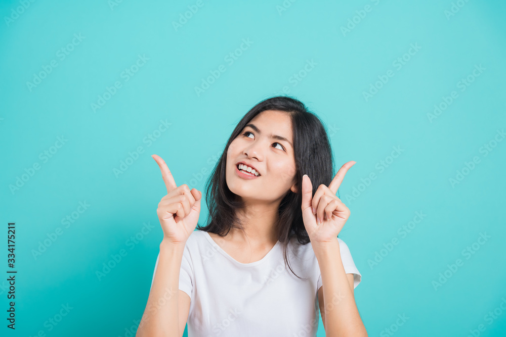 Portrait Asian beautiful young woman standing pointing finger up Portrait Asian beautiful young woman standing pointing finger up