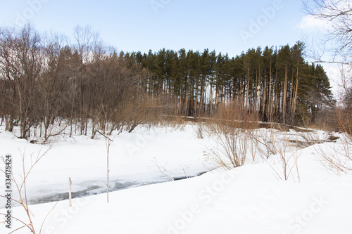 Winter rural river snowy landscape. Forest river in winter snow. Winter Forrest River Peisash