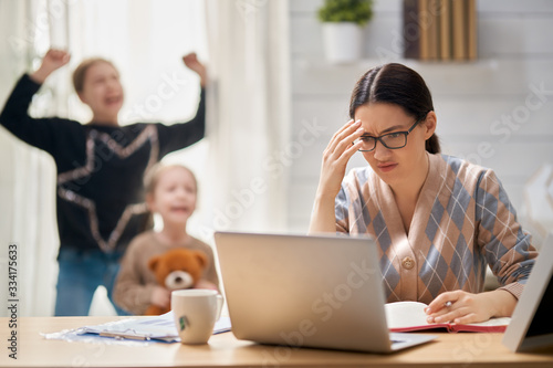 Woman working on a laptop.