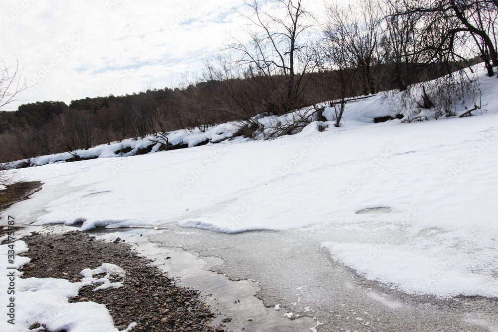 Winter rural river snowy landscape. Forest river in winter snow. Winter Forrest River Peisash Winter rural river snowy landscape. Forest river in winter snow. Winter Forrest River Peisash