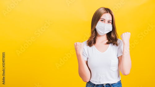 woman wearing face mask protects filter dust pm2.5, virus and air pollution her raise hands glad excited cheerful after recover from illness