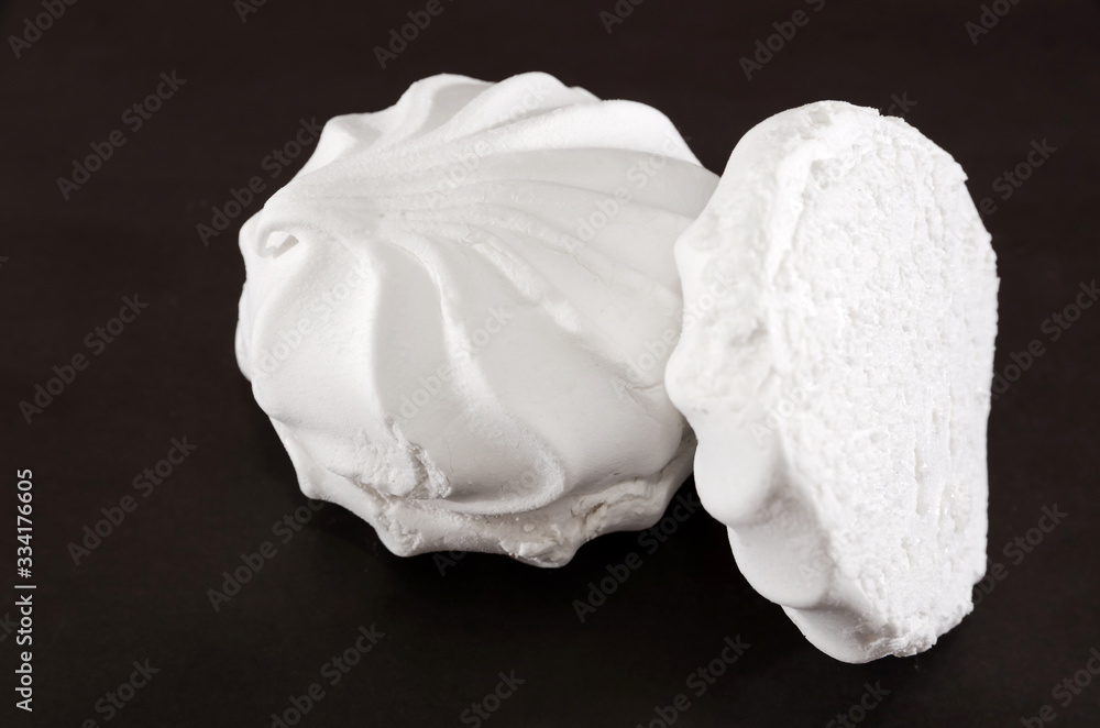 white marshmallows on a black background. Close-up. white marshmallows on a black background. Close-up.