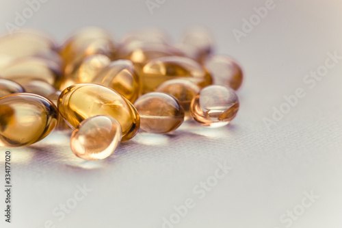Cod liver oil capsules in a fish shape with copy space. Healthcare concept