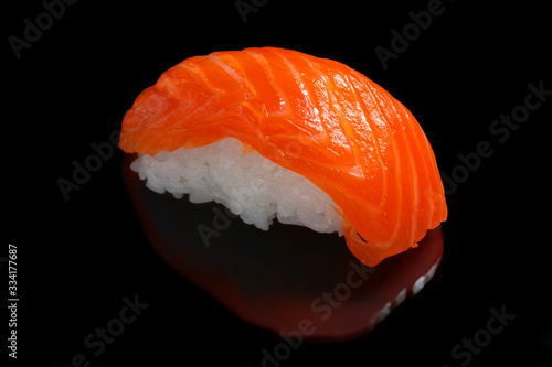 Salmon sushi nigiri isolated on black background. Copy space