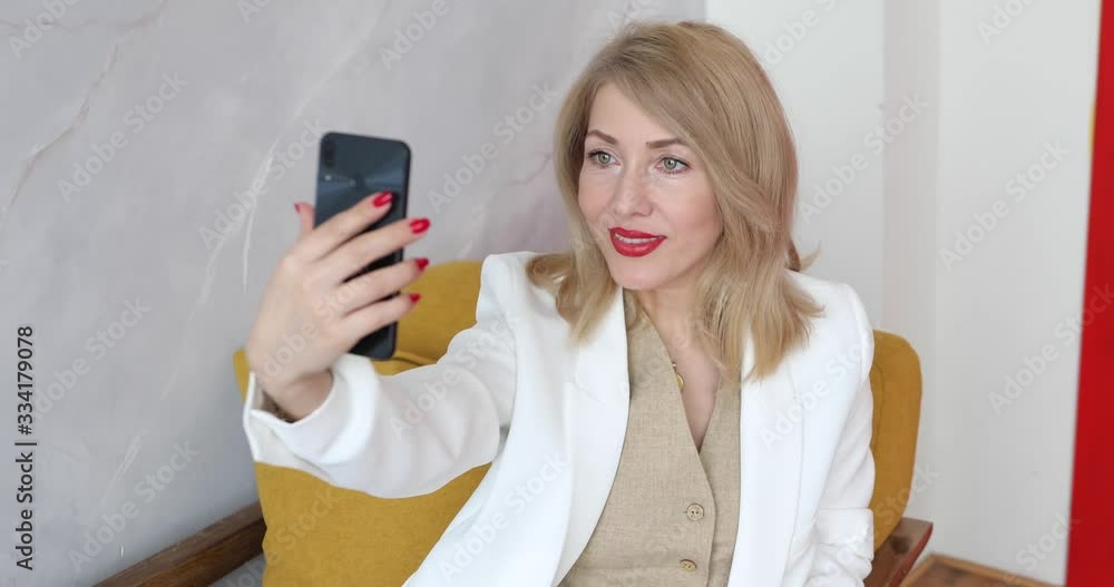 adult woman blonde takes pictures of herself on the phone adult woman blonde takes pictures of herself on the phone