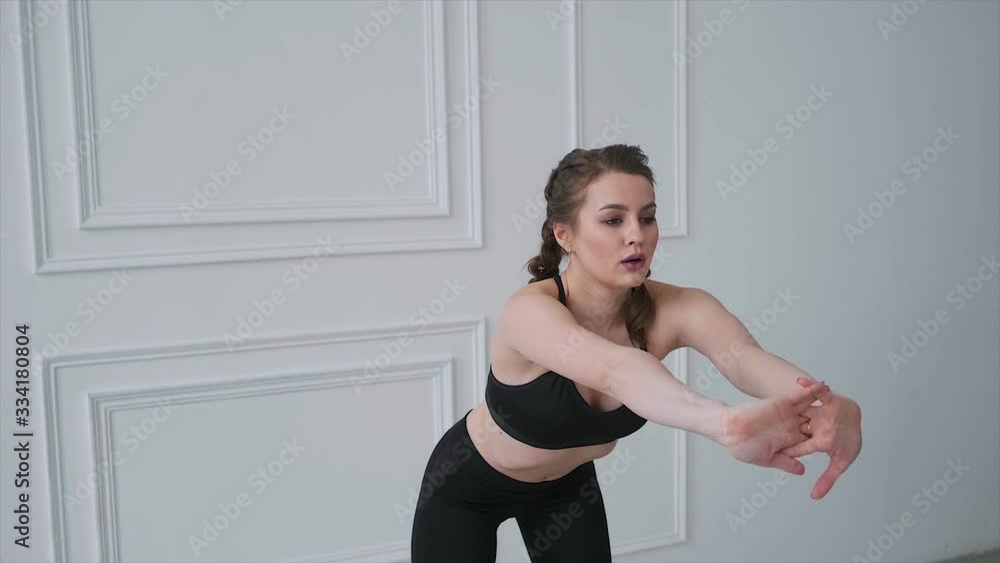 Girl with pigtails in a black tracksuit warming up Girl with pigtails in a black tracksuit warming up