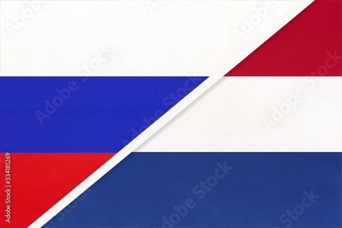 Russia vs Netherlands national flag from textile. Relationship and partnership between two countries.