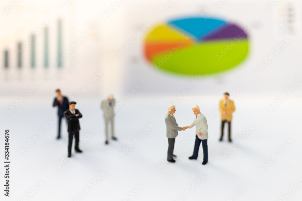 Miniature people : Businessmen earn profits from work, reference the graph to increase benefit. Image use for as a business concept. Miniature people : Businessmen earn profits from work, reference the graph to increase benefit. Image use for as a business concept.