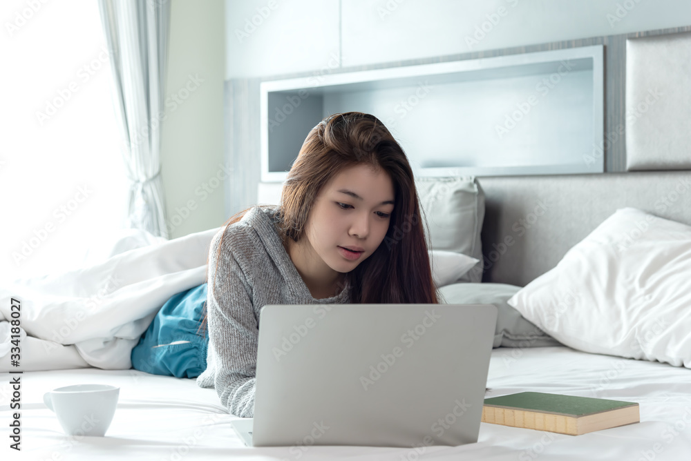 Business asian woman working with laptop at home,private business online lying on bed in bedroom chat and shopping on line. Business asian woman working with laptop at home,private business online lying on bed in bedroom chat and shopping on line.
