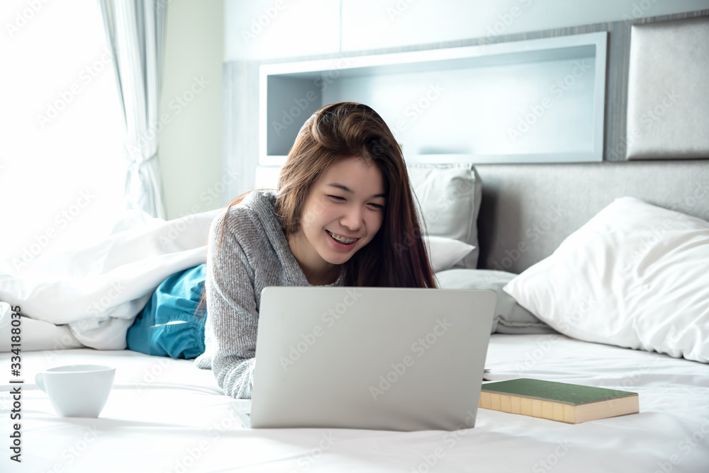 Business asian woman working with laptop at home,private business online lying on bed in bedroom chat and shopping on line. Business asian woman working with laptop at home,private business online lying on bed in bedroom chat and shopping on line.