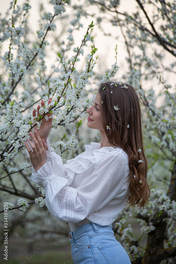 Beautiful girl in a flowered garden